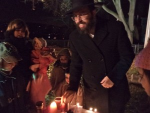 Rabbi Mendell Prus of Doylestown leads havdalah service at Saturday night's Chanukah event
