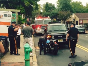 New Hope Police Officer Ken Kozuhowski (left) and Sergeant John Goss (right) assist motorcyclist who crashed his bilke on Sept. 21, as Chief Mike Cummings looks on